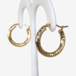 side view of textured gold hoop earrings