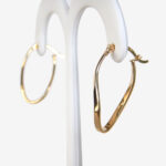 side view of yellow gold wavy hoop earrings