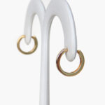 side view of yellow gold small huggie hoop earrings